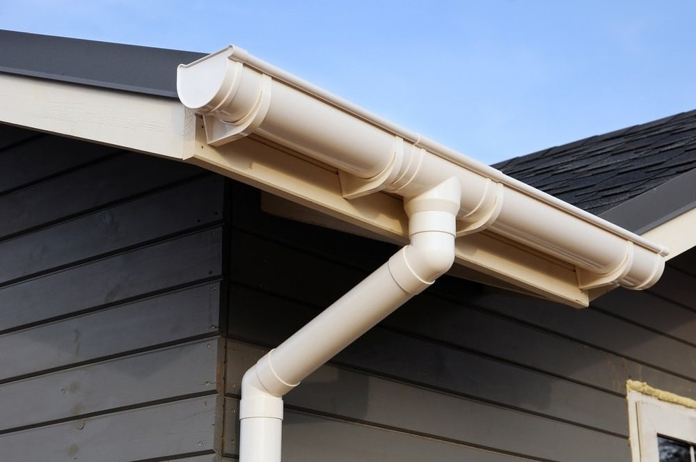 White guttering and downpipe installed on a residential property