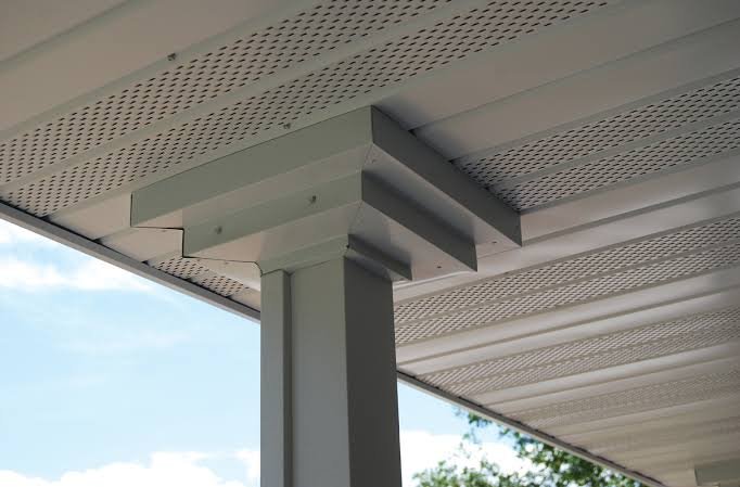Ventilated white soffit system installed beneath a roof edge